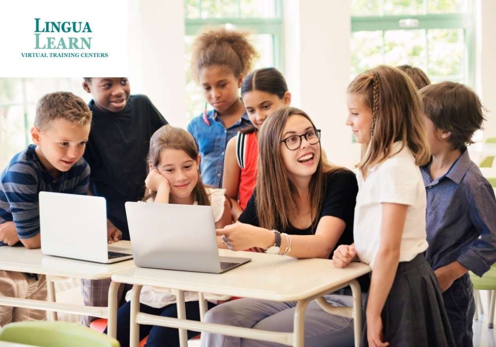 A teacher engaging with a group of excited students around laptops