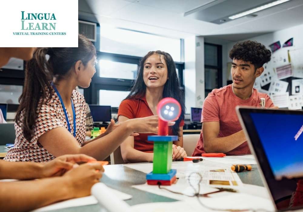 Students collaborating at a table with a light device and materials