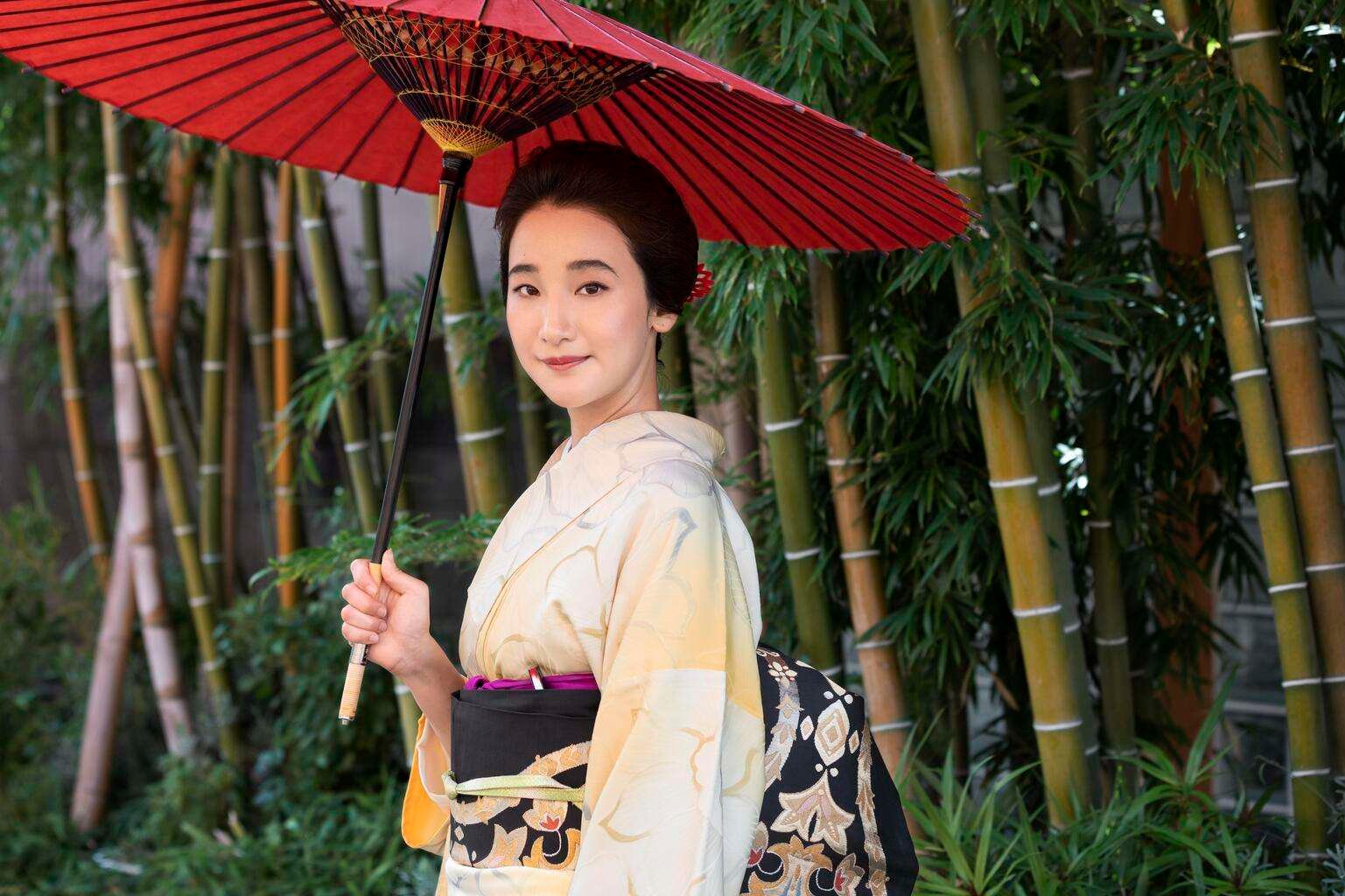 Japanese woman with kimono holding red umbrella